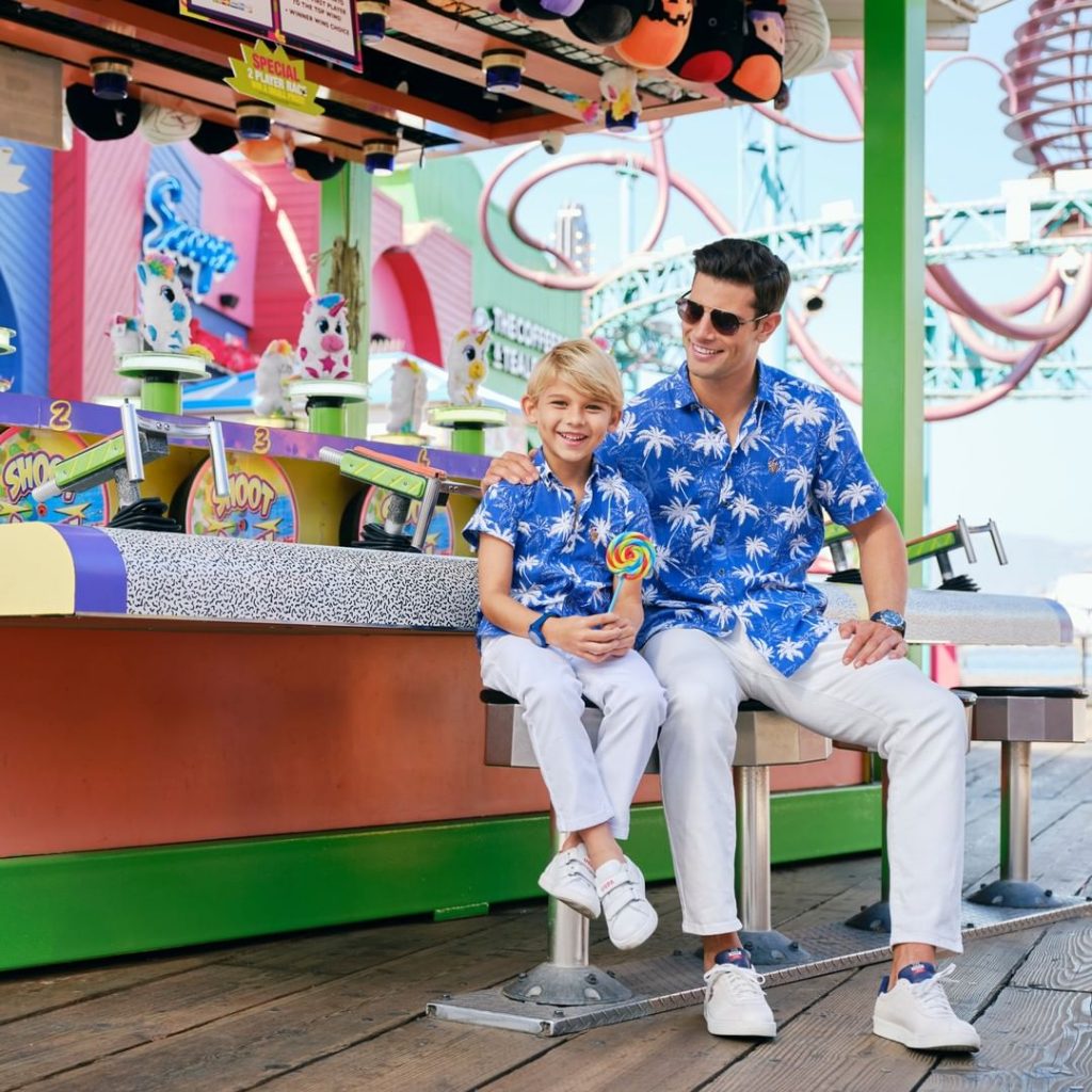 Man and young boy sitting at midway game