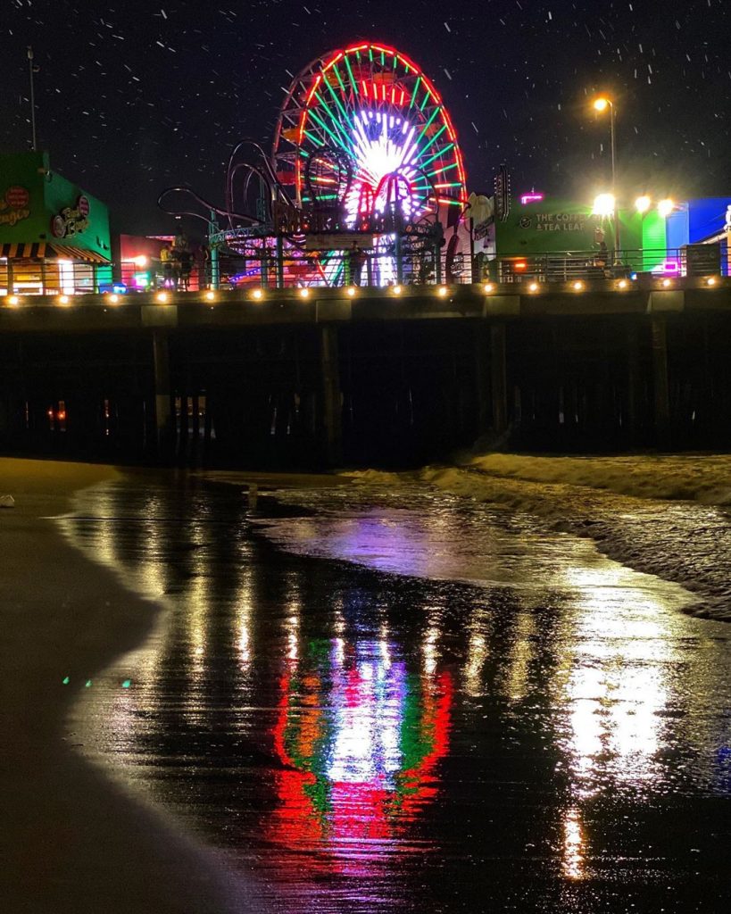 The Santa Monica Pier celebrates the holidays with an 80-foot tall snowman animated on the Pacific Wheel at Pacific Park.