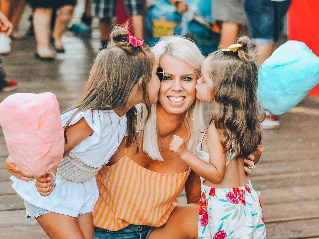 Girls kissing mom with Cotton Candy