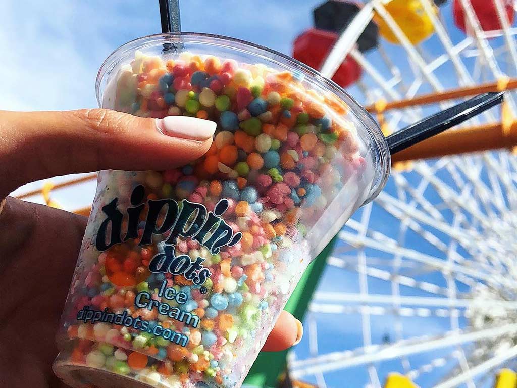 Hand holding cup of Dippin' Dots