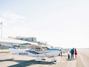 Couple in front of airplane at Santa Monica Airport