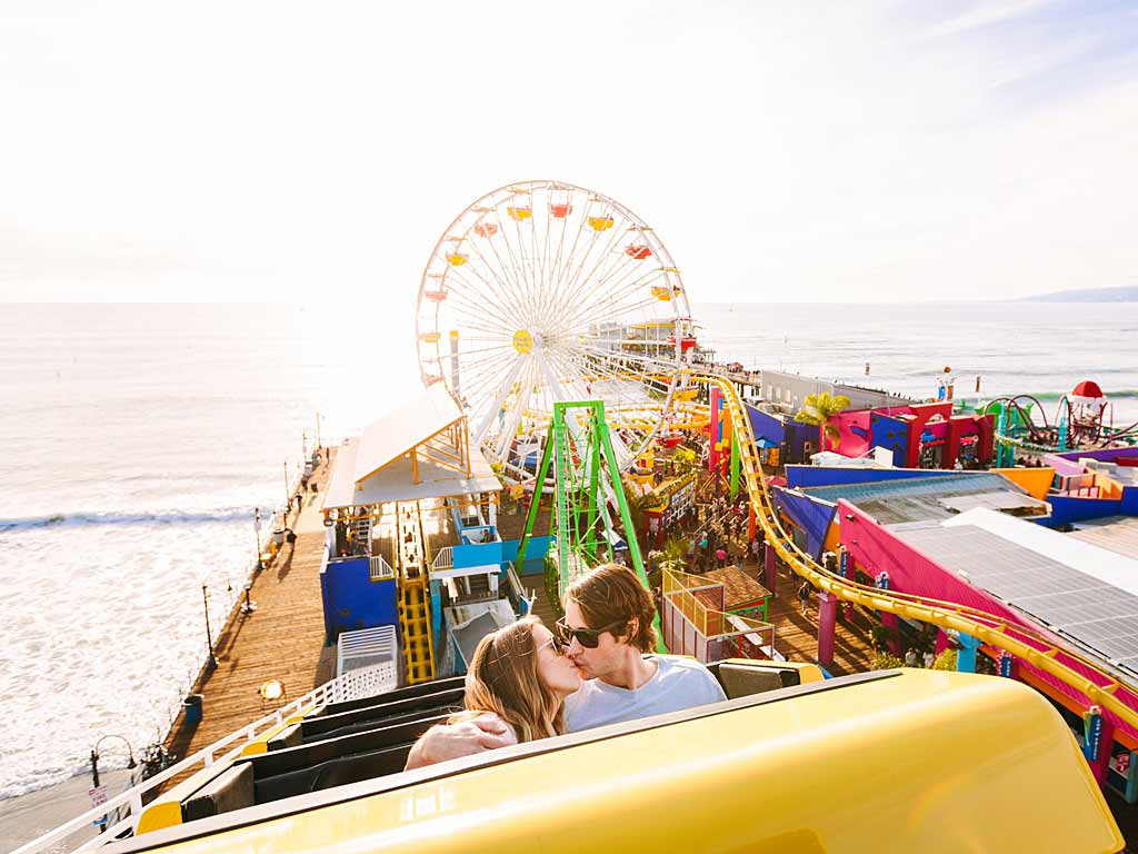 Couple on Santa Monica Pier roller coaster