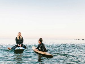 Couple on surfboards in water