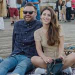 A couple lounges on the boardwalk of the Santa Monica Pier on Locals Night