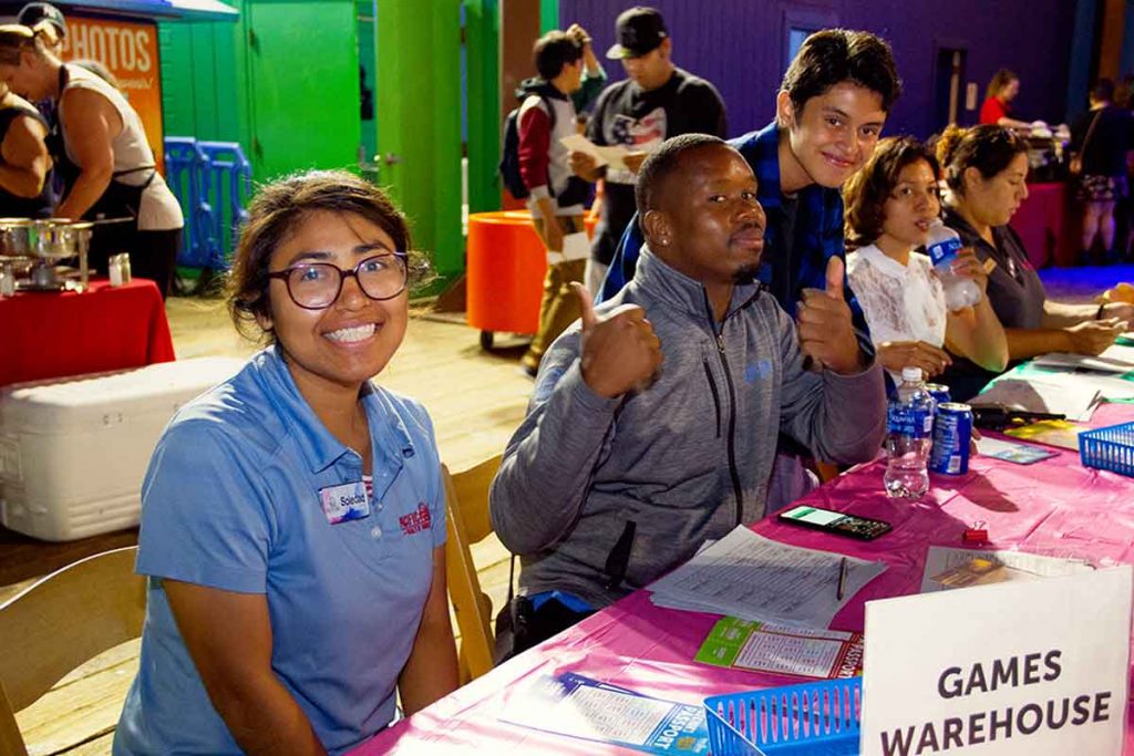 Managers at Pacific Park attend a recruiting table at the Job Fair at Pacific Park