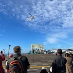 A helicopter hovers above the Santa Monica Pier prepared to lift the Sea Dragon ride off to retirement - Photo by Pacific Park