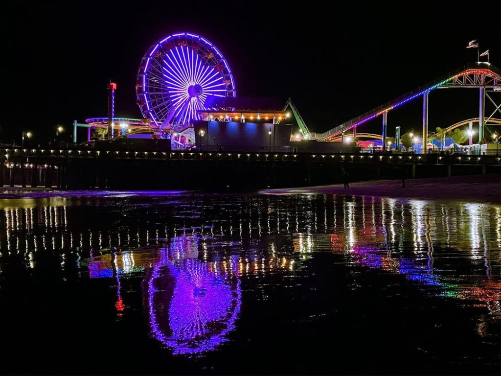 Ferris wheel lit in purple & gold