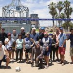 Volleyball players pose in front of the nets just south of the Santa Monica Pier