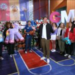 Will Reeve from Good Morning America with a crowd of spectators at the Pacific Park's game-filled midway on the Santa Monica Pier.