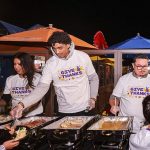 Volunteers in line to receive a Thanksgiving feast served by the Lakers at Pacific Park